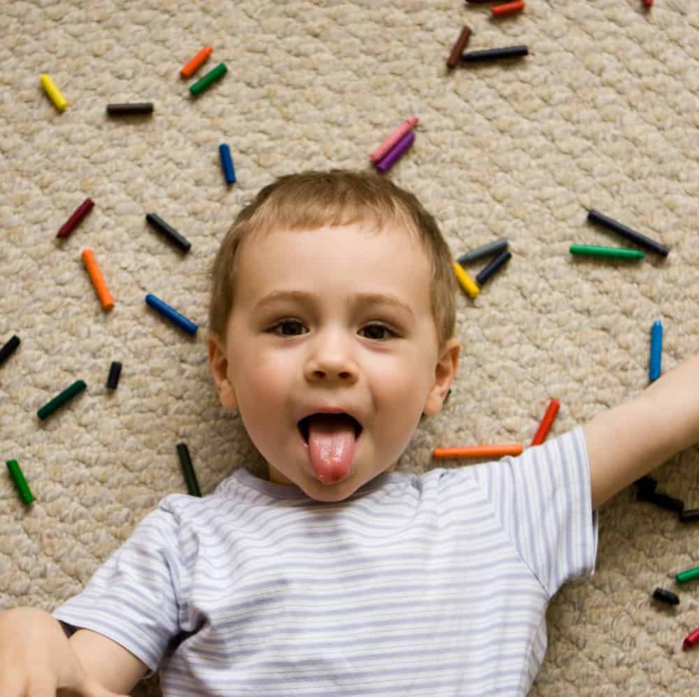 silly-kid-with-crayons-on-carpet